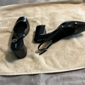 Women’s black patent leather shoes.